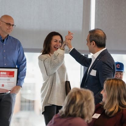 Members celebrating an award with a high five