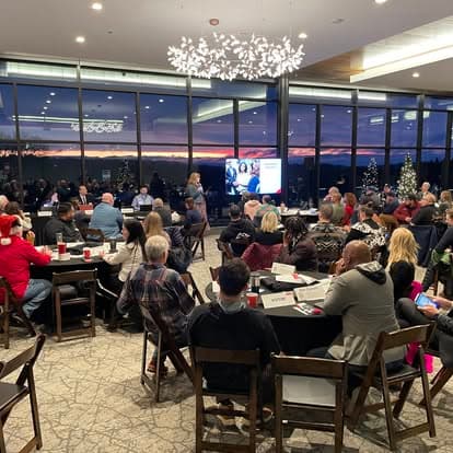 Members gathered at round tables for the chapter's holiday meeting