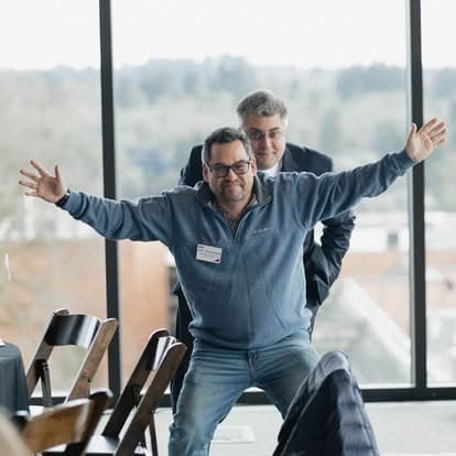 Members sharing a laugh during a meeting